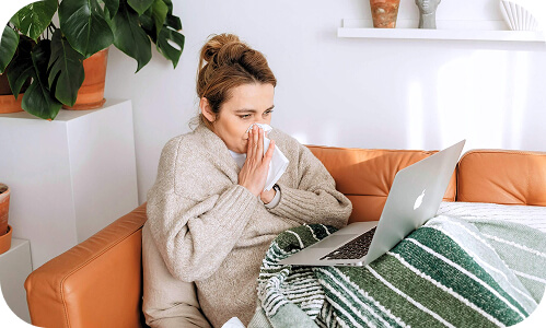New Zealand employee at home working on laptop while sick